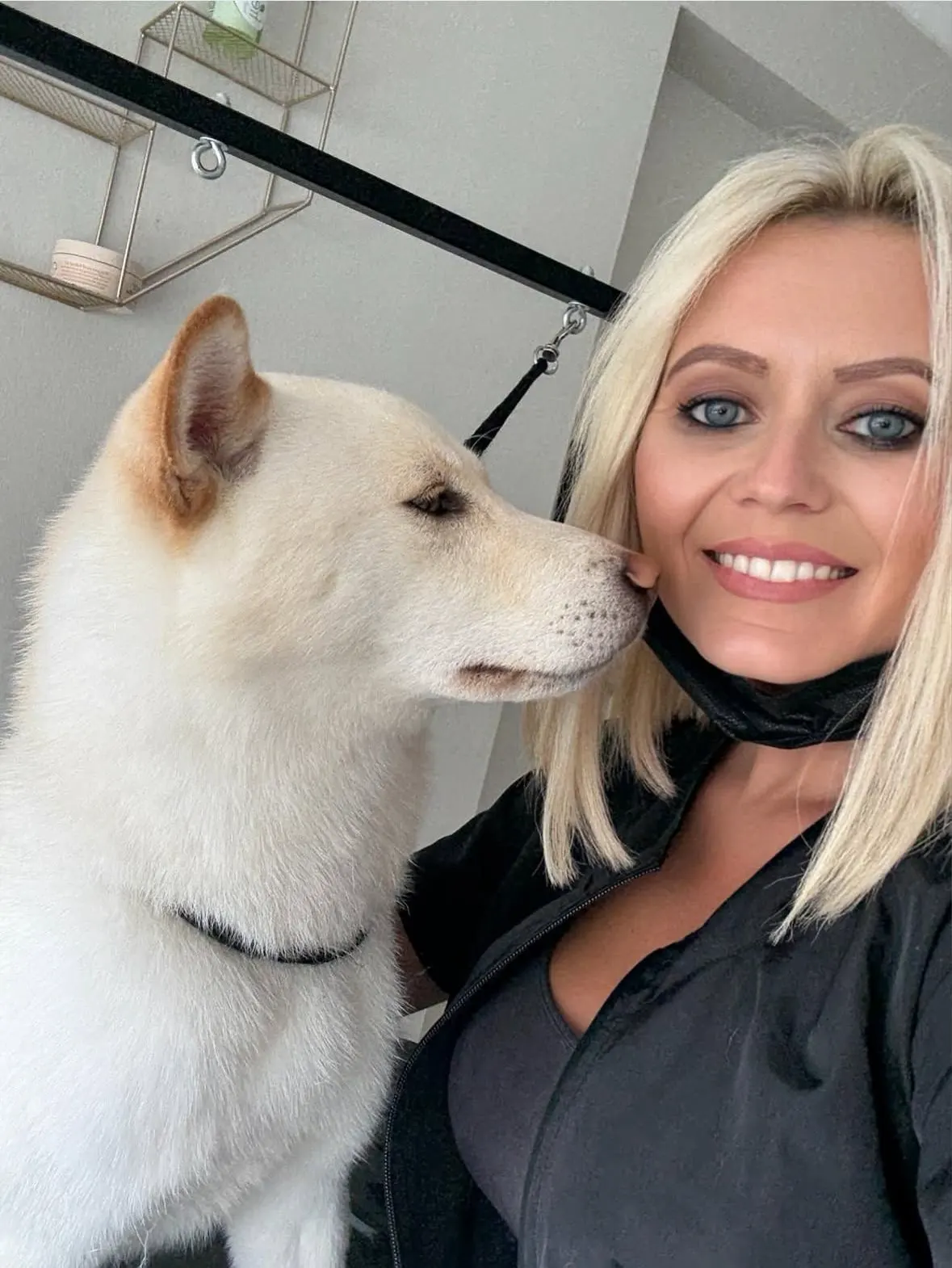 Michelle Adams with a cream Shiba Inu client at The Grooming Boutique grooming arm